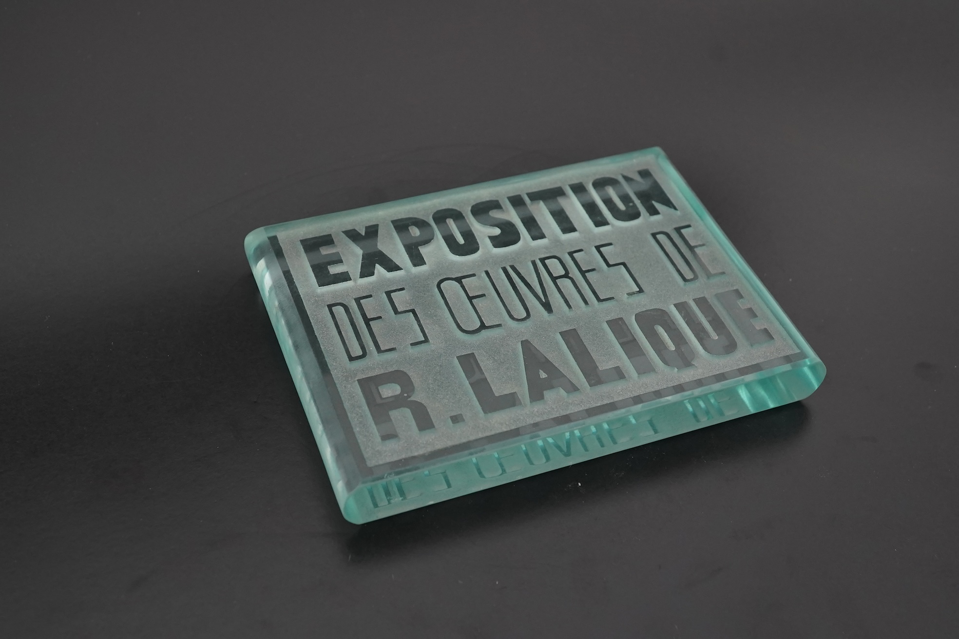 Lalique: A glass advertising plaque 'EXPOSITION DES ŒUVRES DE R.LALIQUE'